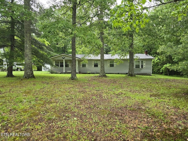 288 Andy Ln, Winfield, TN 37892 - view of front facade featuring metal roof, a chimney, and a front yard