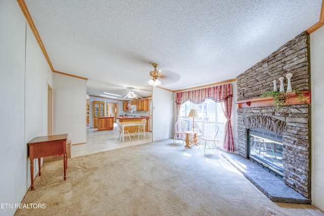 310 Abbott Rd, Lenoir City, TN 37771 - unfurnished living room featuring crown molding, a ceiling fan, a textured ceiling, light colored carpet, and a fireplace