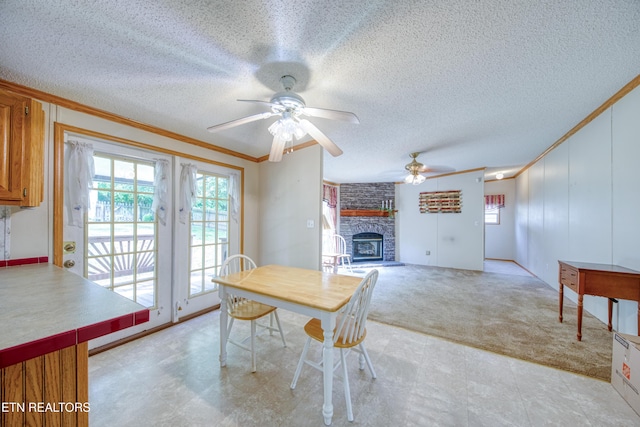 310 Abbott Rd, Lenoir City, TN 37771 - dining space with a ceiling fan, healthy amount of natural light, ornamental molding, a stone fireplace, and light flooring