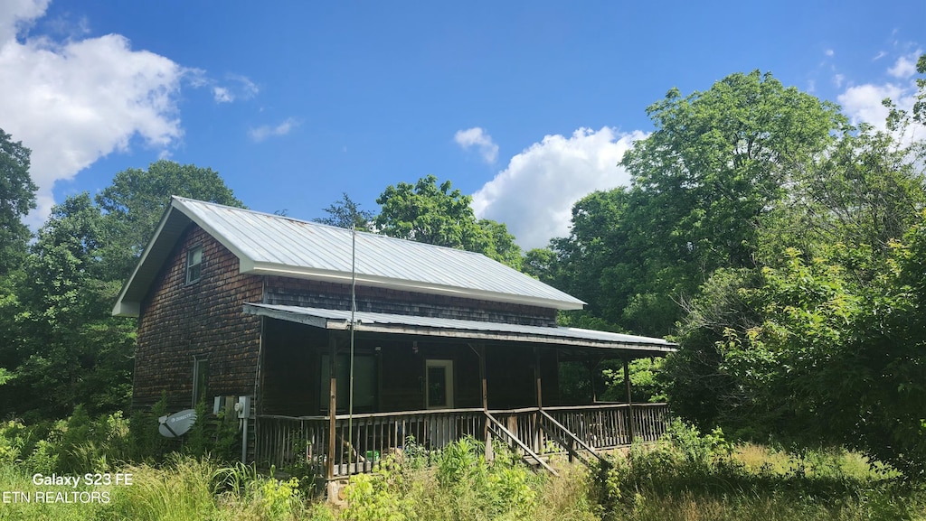 1935 Fairview Rd, Tellico Plains, TN 37385 - back of house with covered porch and metal roof