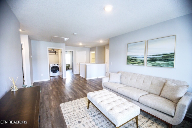 living room featuring washer / dryer, attic access, dark wood-style floors, baseboards, and recessed lighting