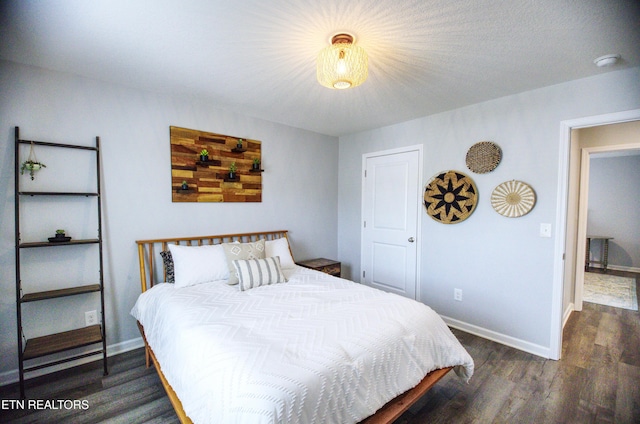 bedroom with wood finished floors and baseboards