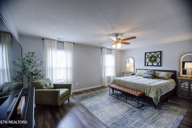 bedroom featuring a textured ceiling, wood finished floors, a ceiling fan, and baseboards
