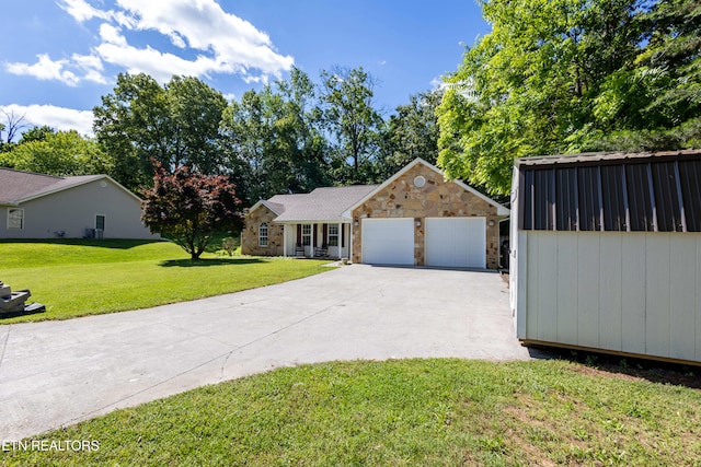 348 Willie D Dr, Jefferson City, TN 37760 - view of front of house featuring stone siding, a front lawn, concrete driveway, and an attached garage