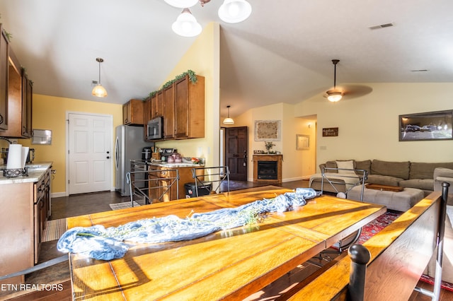 348 Willie D Dr, Jefferson City, TN 37760 - dining space with a fireplace, lofted ceiling, baseboards, and a ceiling fan