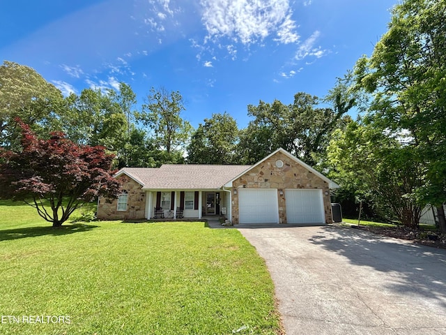 348 Willie D Dr, Jefferson City, TN 37760 - ranch-style house featuring an attached garage, stone siding, covered porch, a front yard, and driveway