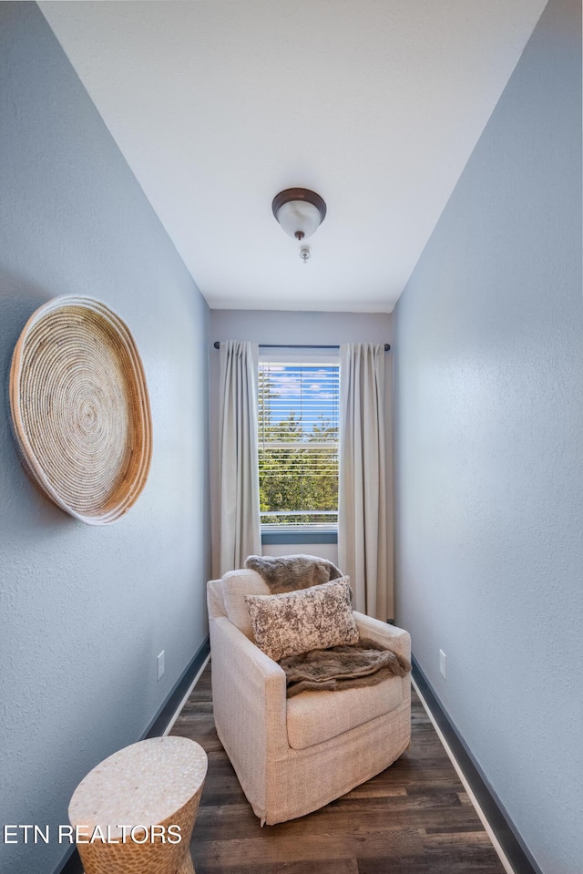 sitting room with wood finished floors and baseboards