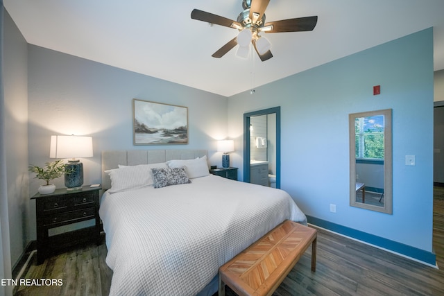 bedroom featuring wood finished floors, baseboards, a ceiling fan, and connected bathroom