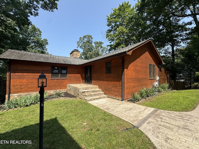 1186 Deerfield Way, Lafollette, TN 37766 - view of front of house featuring a front yard, a chimney, and brick siding