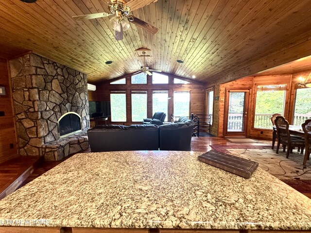 1186 Deerfield Way, Lafollette, TN 37766 - living area featuring ceiling fan, lofted ceiling, dark wood-style flooring, a stone fireplace, and wood ceiling