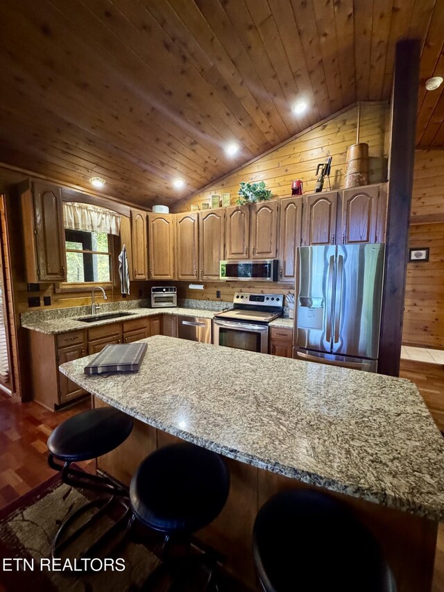 1186 Deerfield Way, Lafollette, TN 37766 - kitchen featuring appliances with stainless steel finishes, a sink, vaulted ceiling, wooden ceiling, and a kitchen breakfast bar