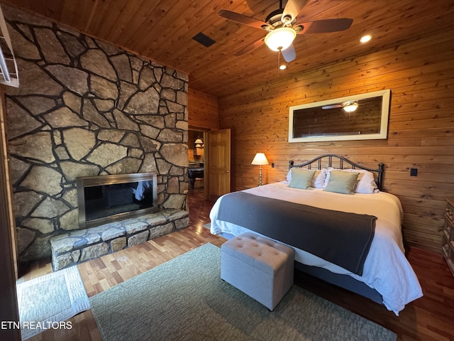 1186 Deerfield Way, Lafollette, TN 37766 - bedroom with wood ceiling, a fireplace, wood finished floors, wooden walls, and ceiling fan
