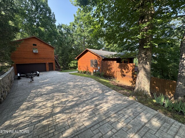 1186 Deerfield Way, Lafollette, TN 37766 - view of patio featuring a detached garage and stairway