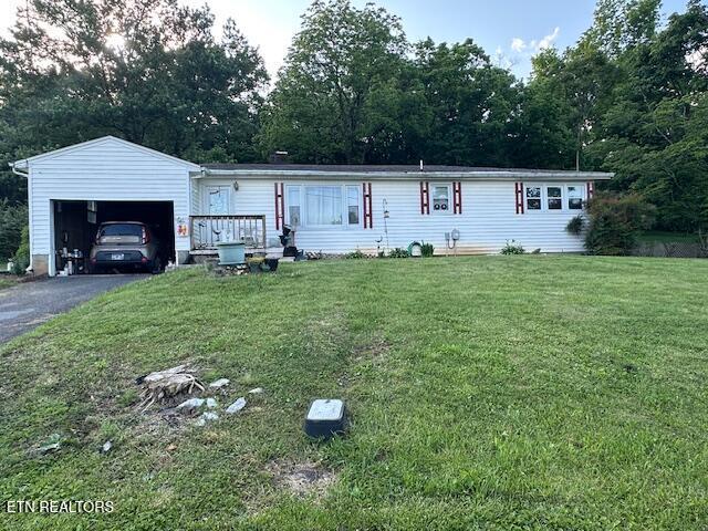 179 Granby Ln, Harrogate, TN 37752 - view of front of house with a front yard, an outdoor structure, driveway, and a garage
