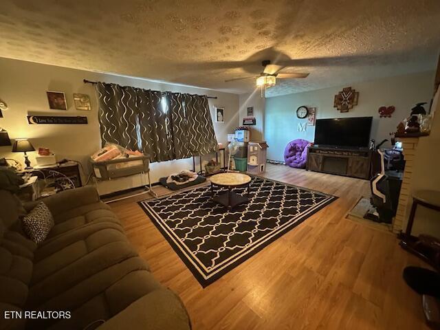 179 Granby Ln, Harrogate, TN 37752 - living room featuring a textured ceiling, ceiling fan, and wood finished floors
