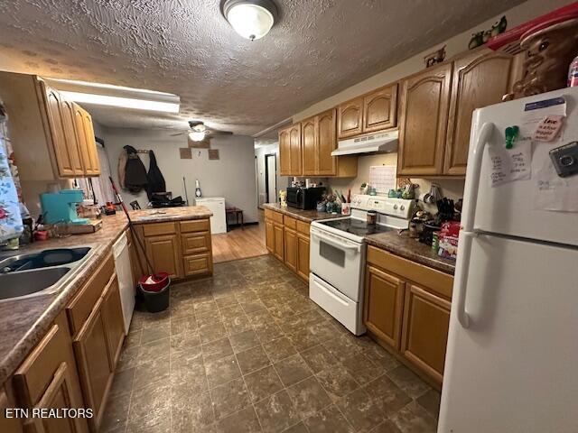 179 Granby Ln, Harrogate, TN 37752 - kitchen with white appliances, a sink, under cabinet range hood, a textured ceiling, and a peninsula