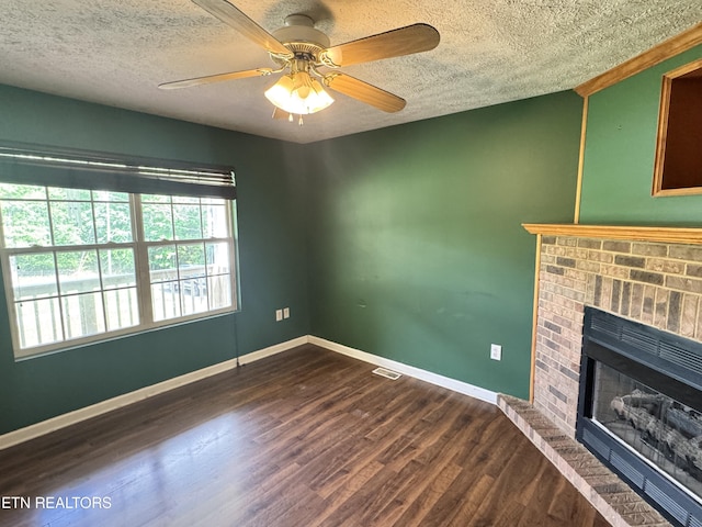 211 Jamie St, Maynardville, TN 37807 - unfurnished living room featuring a textured ceiling, a fireplace, dark wood-style floors, baseboards, and a ceiling fan