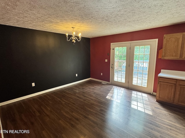 211 Jamie St, Maynardville, TN 37807 - unfurnished dining area with a chandelier, dark wood-style flooring, baseboards, and a textured ceiling