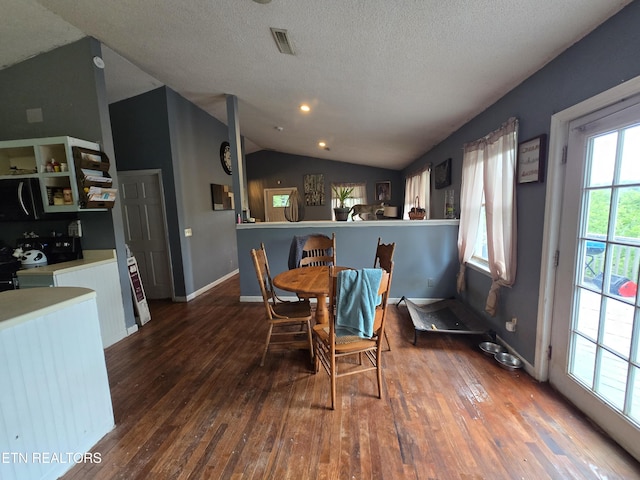 291 Tall Oaks Dr, Pennington Gap, VA 24277 - dining area featuring lofted ceiling, hardwood / wood-style floors, a textured ceiling, and baseboards