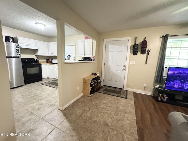 108 E Hunter Cir, Oak Ridge, TN 37830 - entrance foyer with a textured ceiling, baseboards, and light tile patterned floors