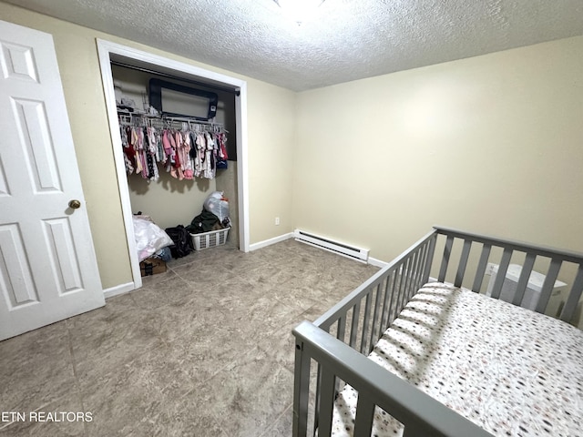 108 E Hunter Cir, Oak Ridge, TN 37830 - carpeted bedroom with baseboard heating, a closet, a textured ceiling, and baseboards