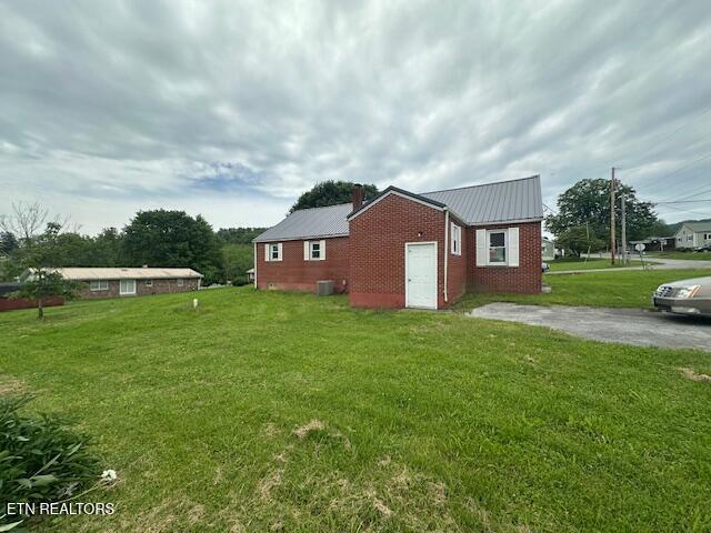 156 Beatty Rd, Rose Hill, VA 24281 - view of side of home with a yard, metal roof, a chimney, and cooling unit