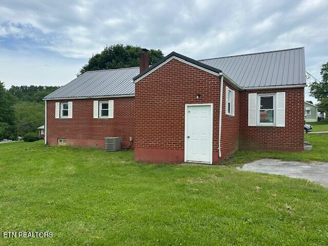 156 Beatty Rd, Rose Hill, VA 24281 - back of house featuring metal roof, brick siding, and a yard