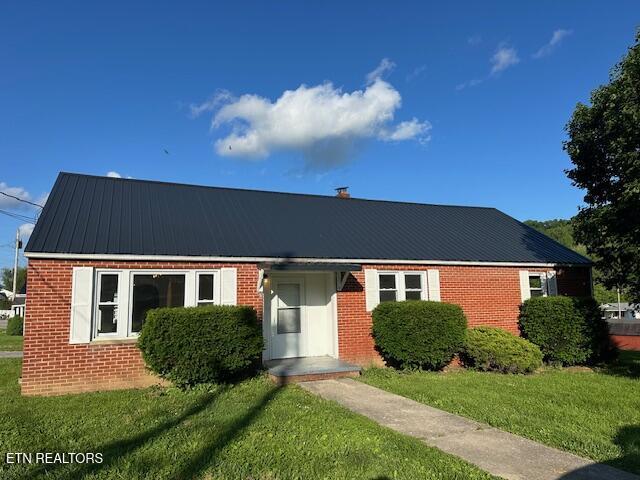 156 Beatty Rd, Rose Hill, VA 24281 - view of front of house featuring brick siding, a front yard, and metal roof