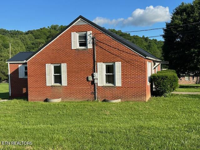 156 Beatty Rd, Rose Hill, VA 24281 - view of side of property featuring brick siding and a lawn