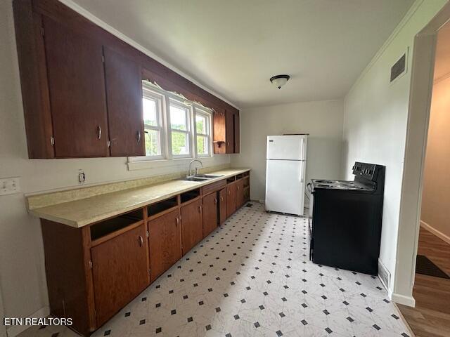 156 Beatty Rd, Rose Hill, VA 24281 - kitchen featuring black range with electric cooktop, freestanding refrigerator, light countertops, and light flooring