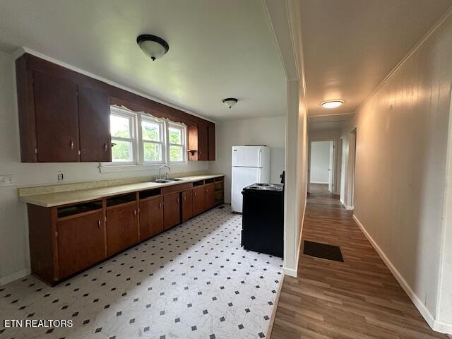 156 Beatty Rd, Rose Hill, VA 24281 - kitchen featuring light countertops, baseboards, freestanding refrigerator, crown molding, and a sink