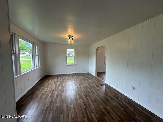 156 Beatty Rd, Rose Hill, VA 24281 - empty room with arched walkways, dark wood-style flooring, and baseboards