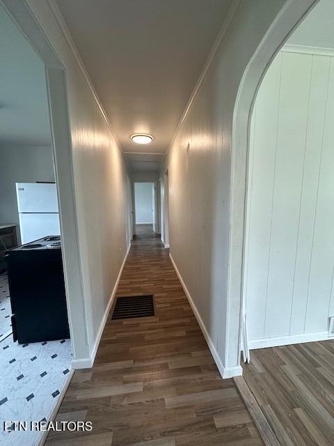 156 Beatty Rd, Rose Hill, VA 24281 - hallway with wood finished floors, arched walkways, crown molding, baseboards, and a decorative wall