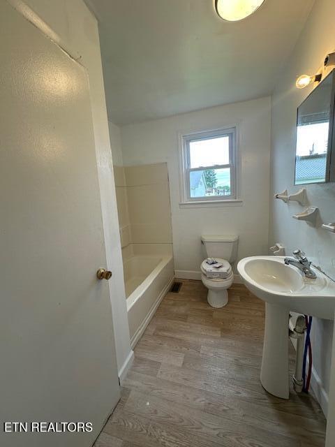156 Beatty Rd, Rose Hill, VA 24281 - full bathroom with a bathtub, toilet, wood finished floors, baseboards, and a shower