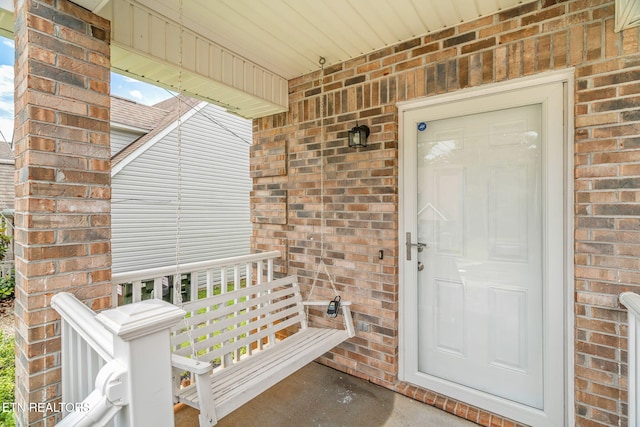 1051 Nod St, Knoxville, TN 37932 - doorway to property featuring brick siding and a porch