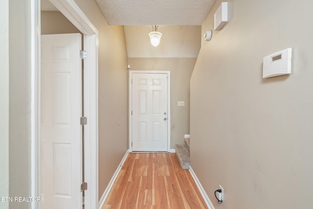 1051 Nod St, Knoxville, TN 37932 - doorway featuring light wood-type flooring, baseboards, a textured ceiling, and stairway