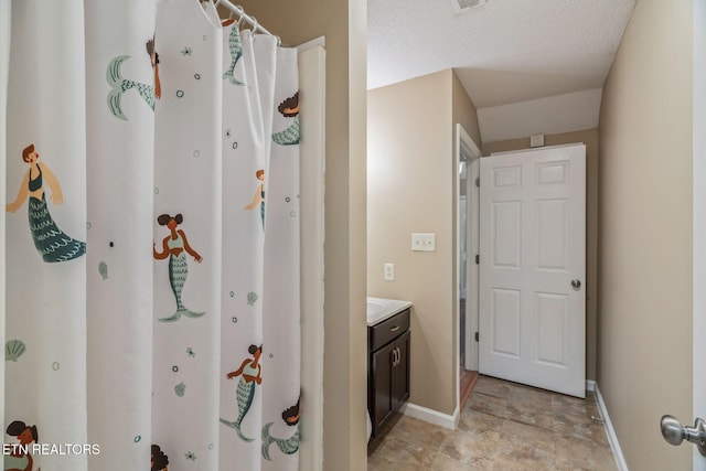 1051 Nod St, Knoxville, TN 37932 - bathroom featuring baseboards, stone finish flooring, vanity, and a shower with shower curtain
