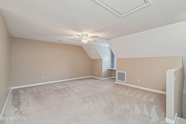 1051 Nod St, Knoxville, TN 37932 - bonus room featuring carpet floors, a ceiling fan, a textured ceiling, baseboards, and lofted ceiling