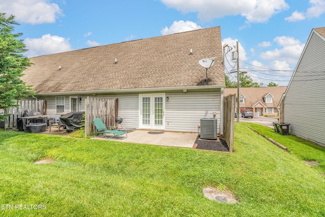 1051 Nod St, Knoxville, TN 37932 - back of property featuring a patio area, central AC unit, roof with shingles, and a lawn