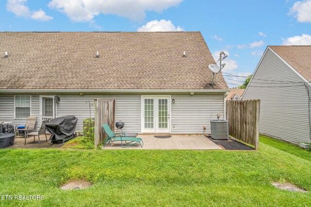 1051 Nod St, Knoxville, TN 37932 - rear view of house with cooling unit, a patio, a shingled roof, and a lawn