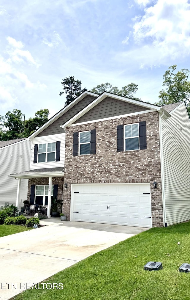 1013 Curly Top Ln, Knoxville, TN 37932 - craftsman-style home featuring an attached garage, concrete driveway, a front yard, a porch, and brick siding