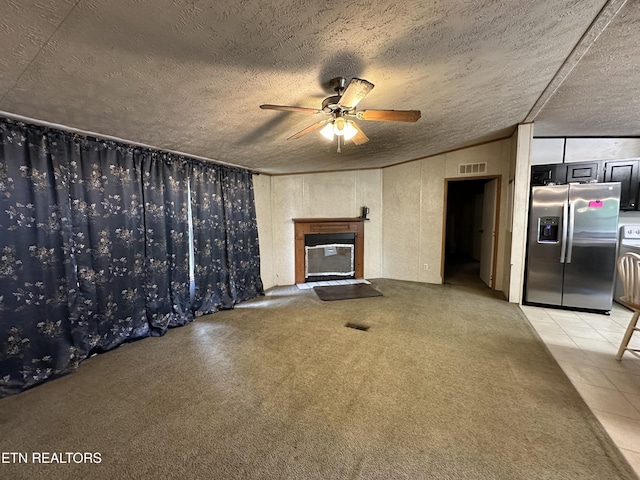 214 Hickory Grove Rd, Madisonville, TN 37354 - unfurnished living room with ceiling fan, lofted ceiling, a glass covered fireplace, light tile patterned flooring, and a textured ceiling