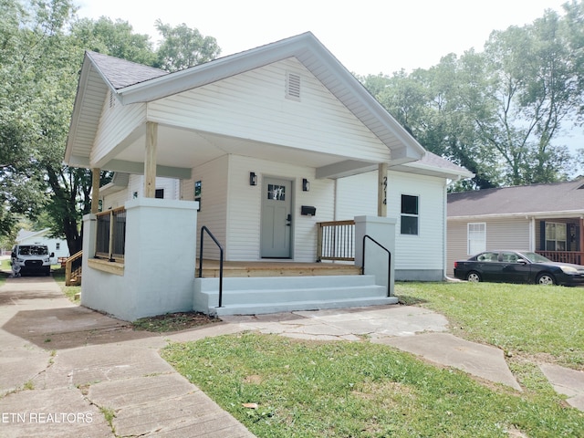 2714 E 5th Ave, Knoxville, TN 37914 - view of front of home featuring a front yard, a porch, and roof with shingles
