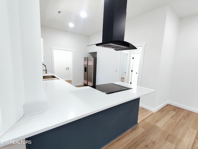 2714 E 5th Ave, Knoxville, TN 37914 - kitchen featuring black electric stovetop, island exhaust hood, a sink, light wood-style flooring, and stainless steel refrigerator with ice dispenser