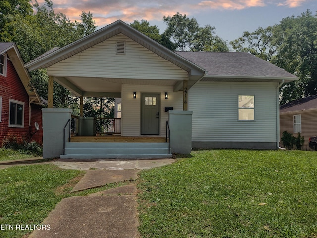 2714 E 5th Ave, Knoxville, TN 37914 - view of front of property featuring covered porch, a lawn, and roof with shingles
