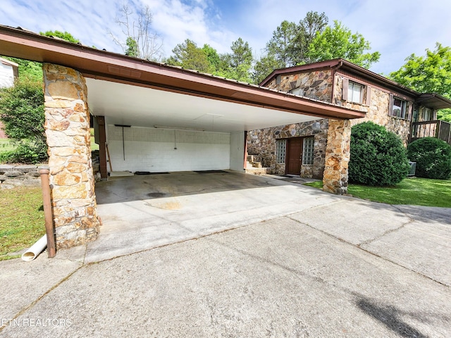 1711 Rocky Branch Rd, Rutledge, TN 37861 - view of front of home with stone siding, concrete driveway, and a carport