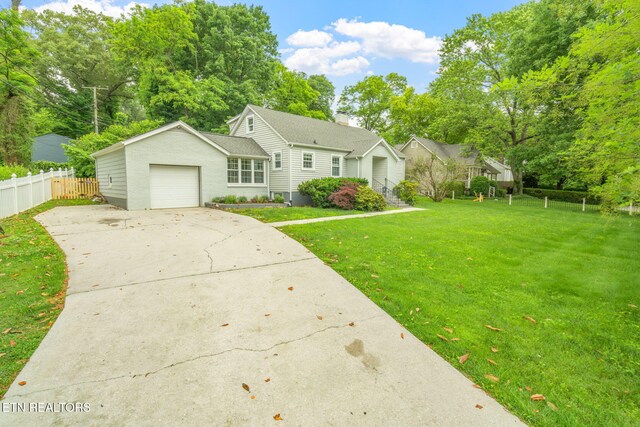4051 Sutherland Ave, Knoxville, TN 37919 - view of front facade with concrete driveway, a garage, and view of wooded area
