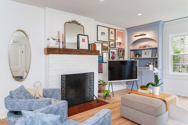 4051 Sutherland Ave, Knoxville, TN 37919 - living room with wood finished floors, a fireplace, built in shelves, recessed lighting, and ornamental molding