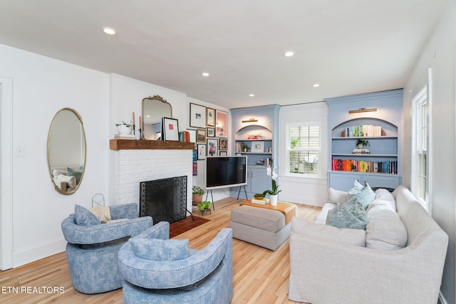 4051 Sutherland Ave, Knoxville, TN 37919 - living area featuring wood finished floors, a brick fireplace, recessed lighting, and baseboards