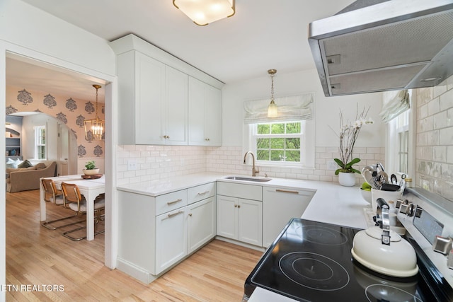 4051 Sutherland Ave, Knoxville, TN 37919 - kitchen featuring a sink, extractor fan, electric range, light wood-style floors, and white cabinetry